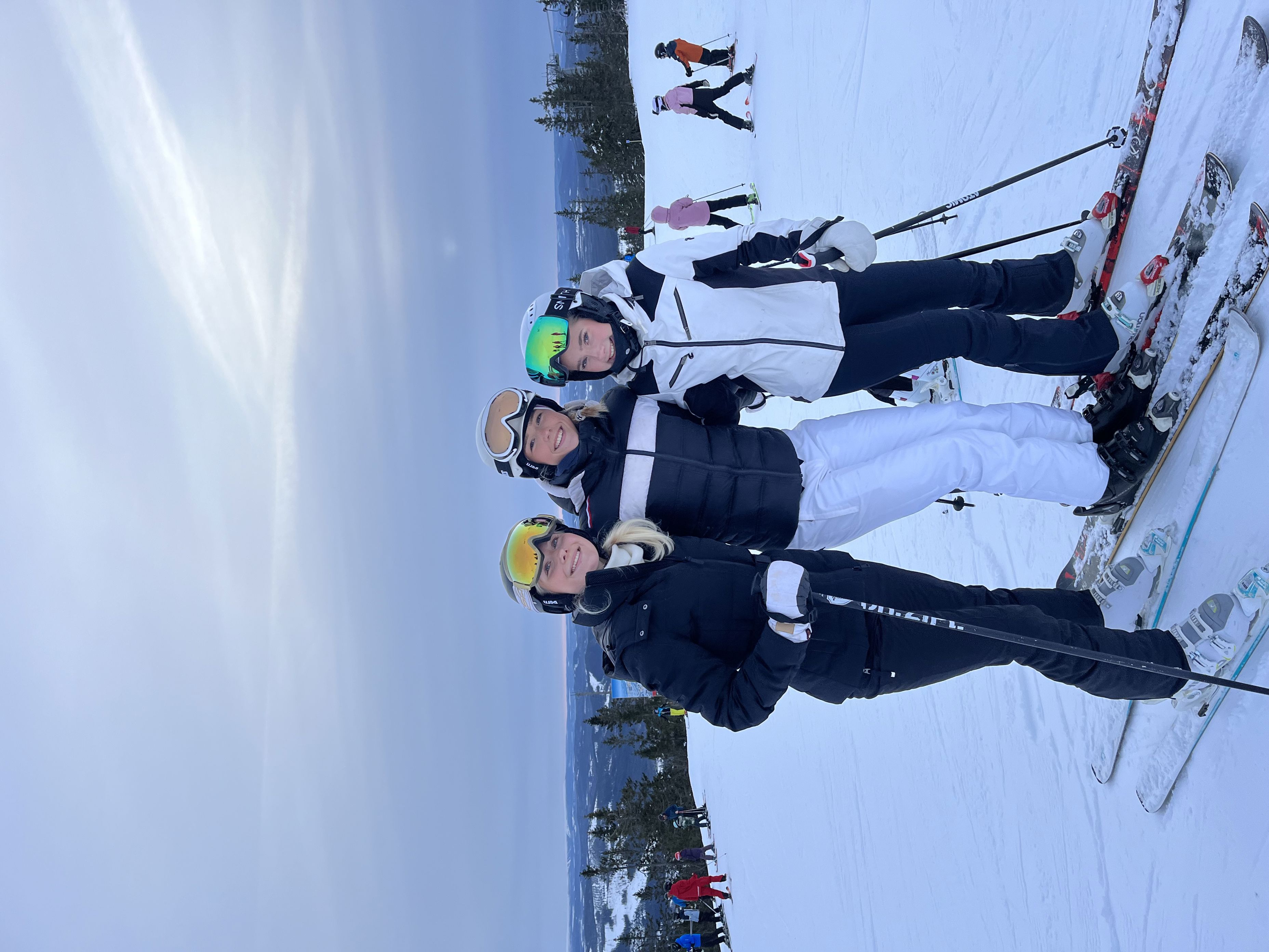 En gruppe mennesker poserer på snøski En gruppe mennesker poserer på snøski