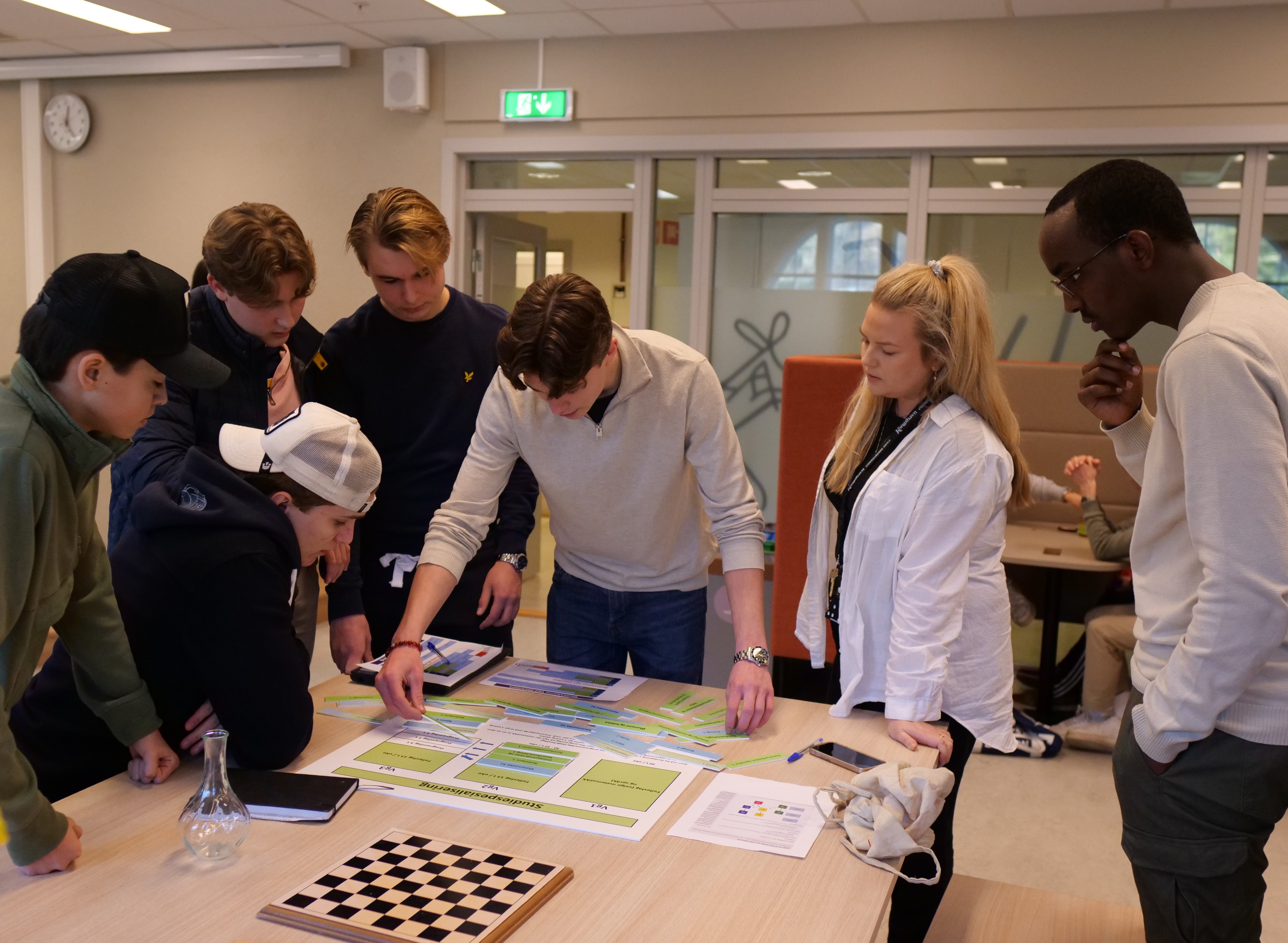 En gruppe mennesker som ser på et kart på et bord