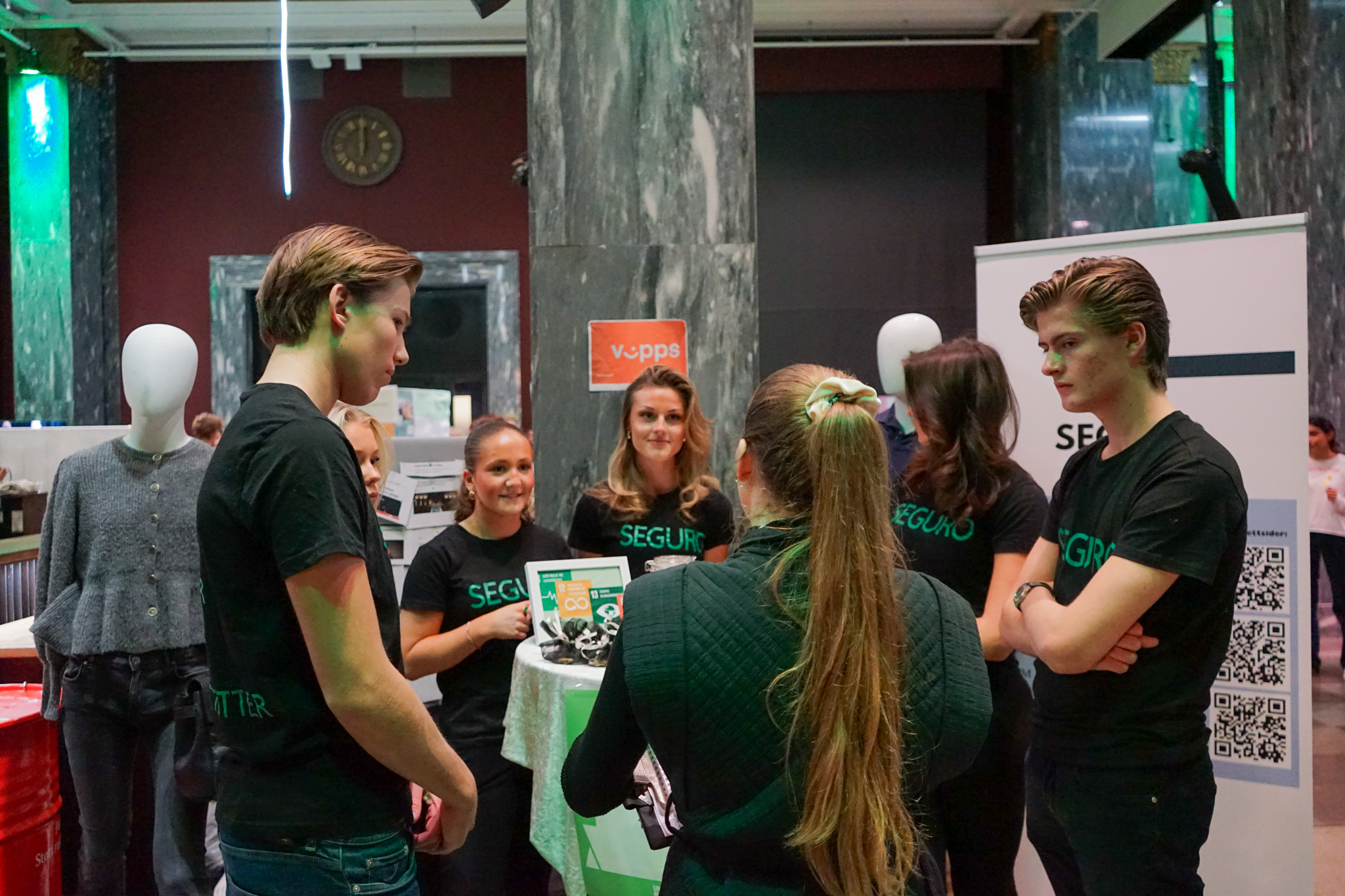 en gruppe mennesker som står i et rom