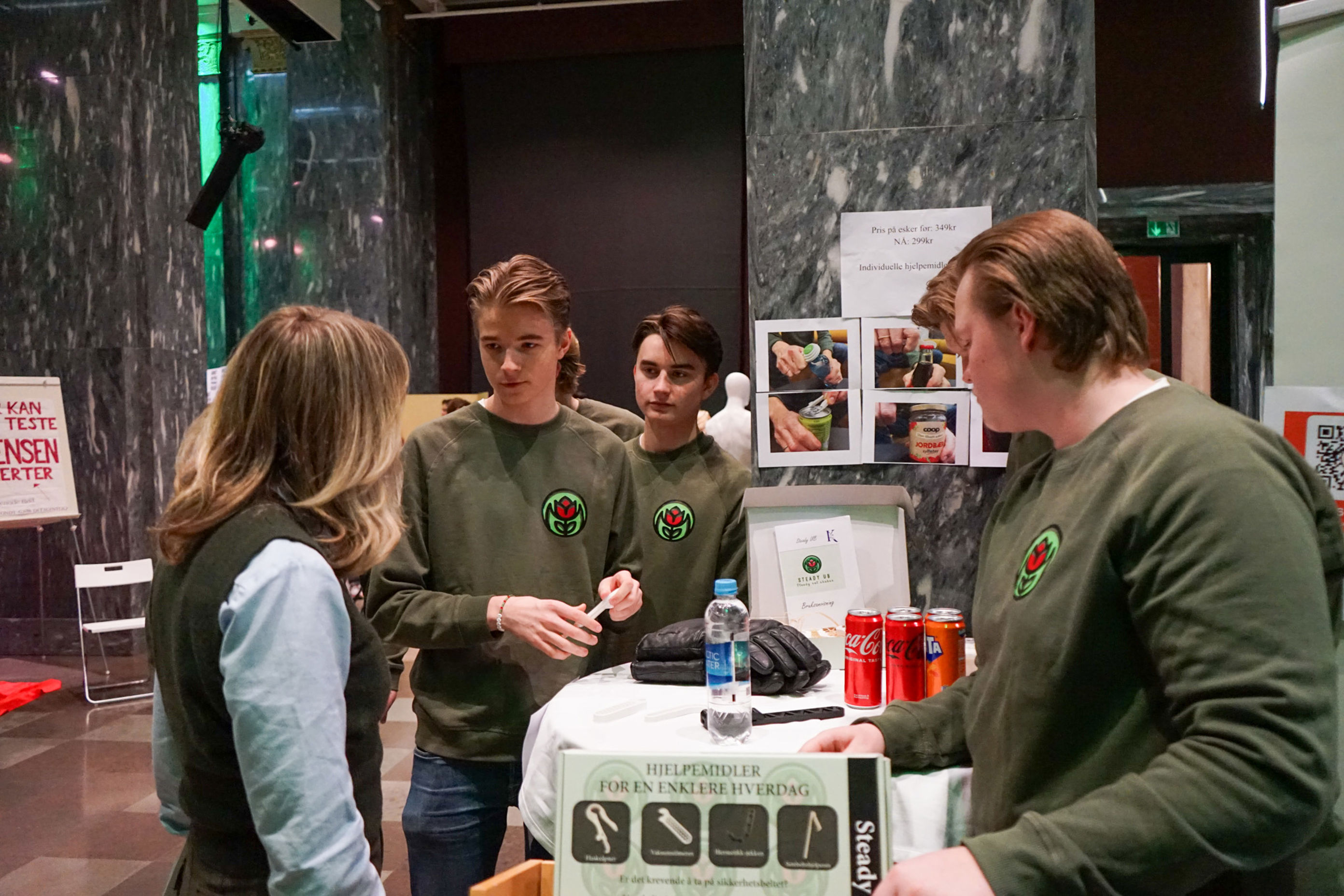 en gruppe mennesker som står rundt et bord med en datamaskin