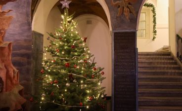 Et pyntet juletre i en steinbygning